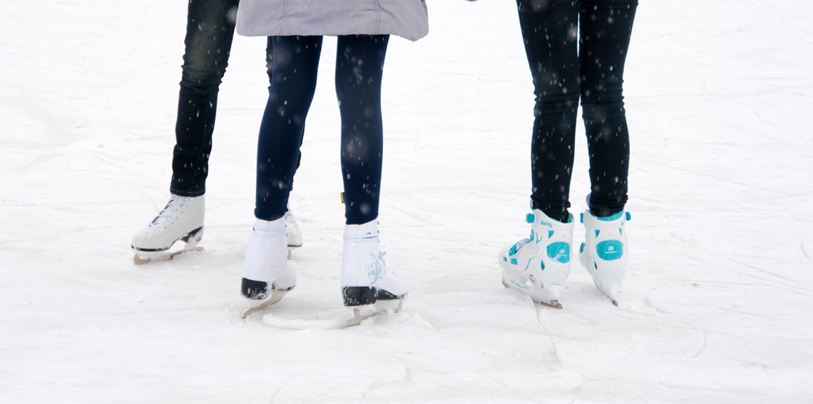 Three girls chatting on the ice rink Ice Skating
