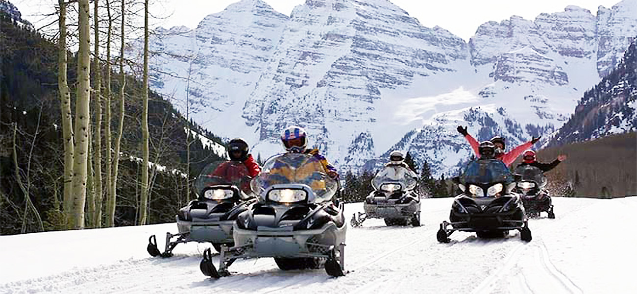 Group of riders Snowmobiling coming back from Maroon Bells in Aspen, Colorado 