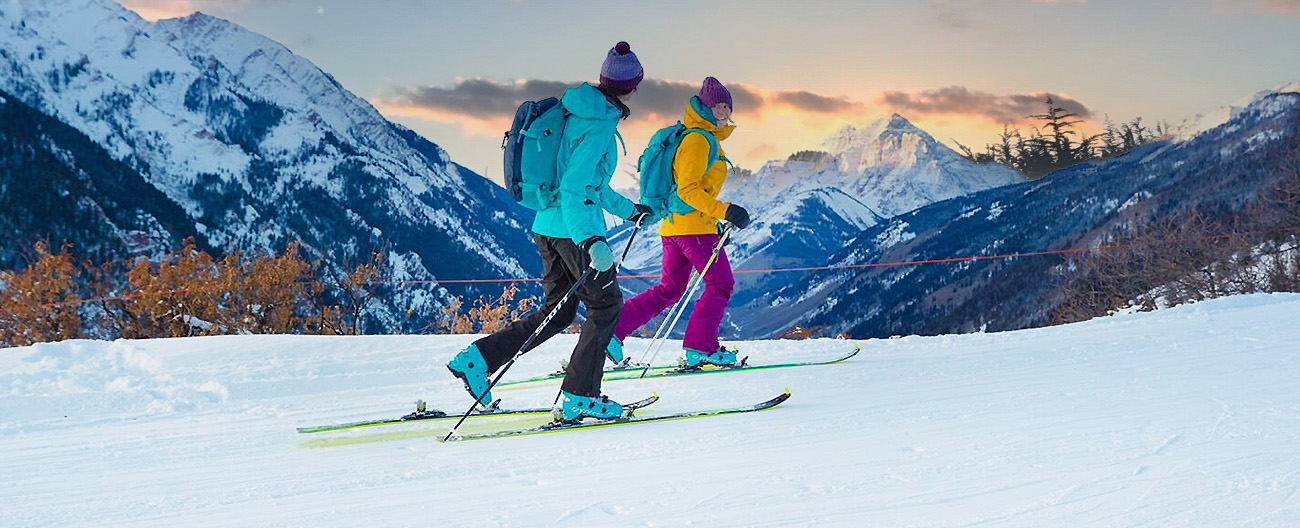 Two women Uphill Skiing up Tiehack on Buttermilk Mountain in Aspen, Colorado 