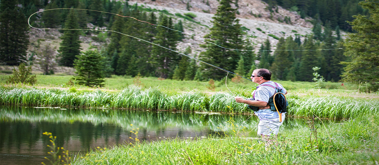 Fly fishing in Aspen, Colorado with scenic mountain views.
