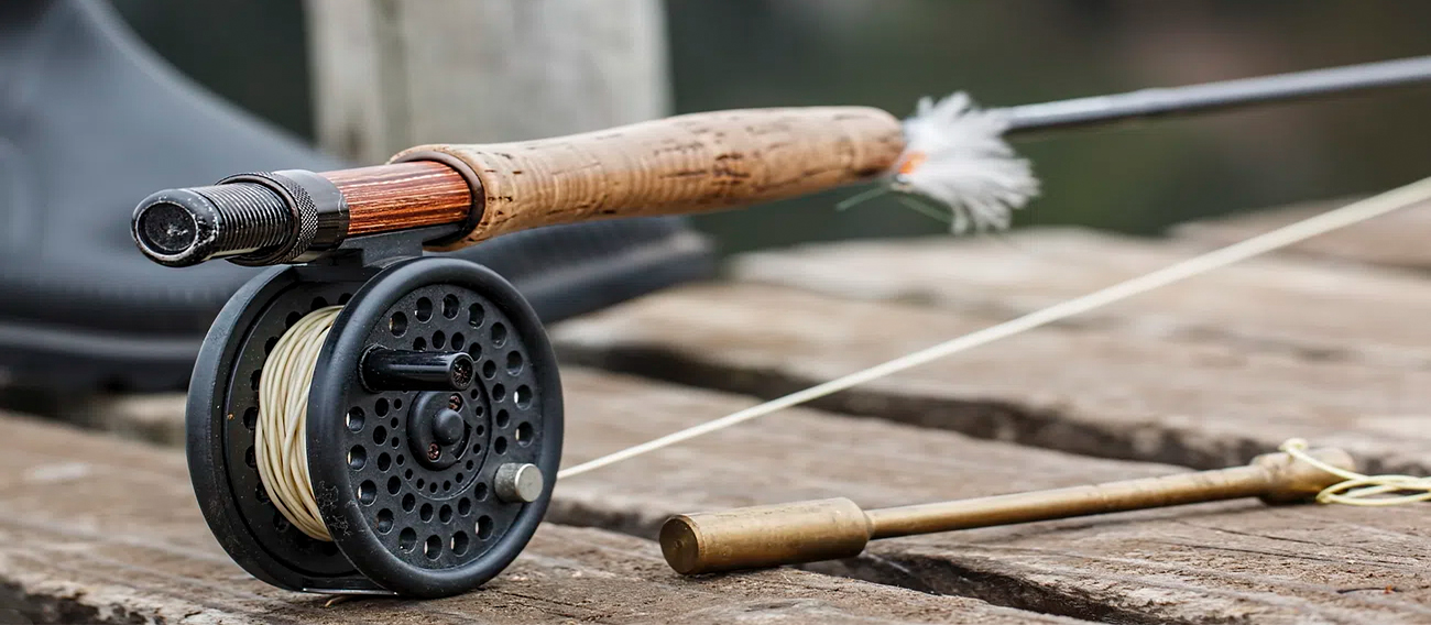 Fly fishing rod and reel on wooden table in Aspen.