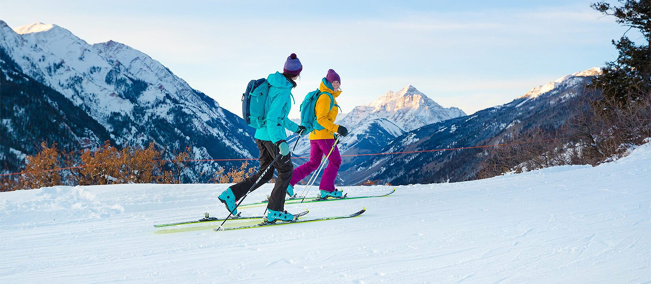 Two women going up Tiehack Ski Hill on Buttermilk to Backcountry skiing in Aspen, Colorado