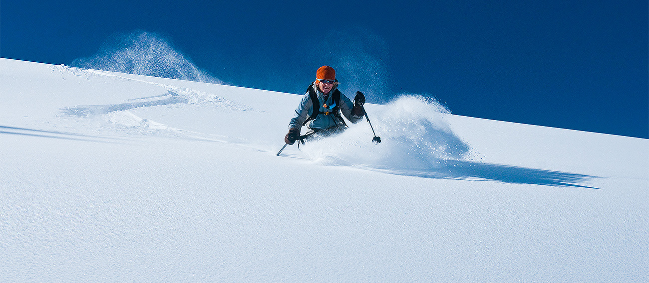Women skiing down Highlands Bowl in Aspen, Colorado during winter