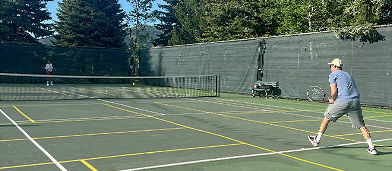 Two men playing Tennis on Iselin Tennis Courts in Aspen, Colorado