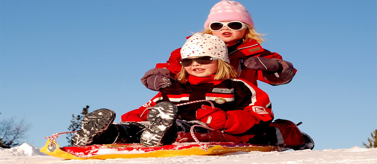 Two girls waiting at the top of Sledding Hill to Sled