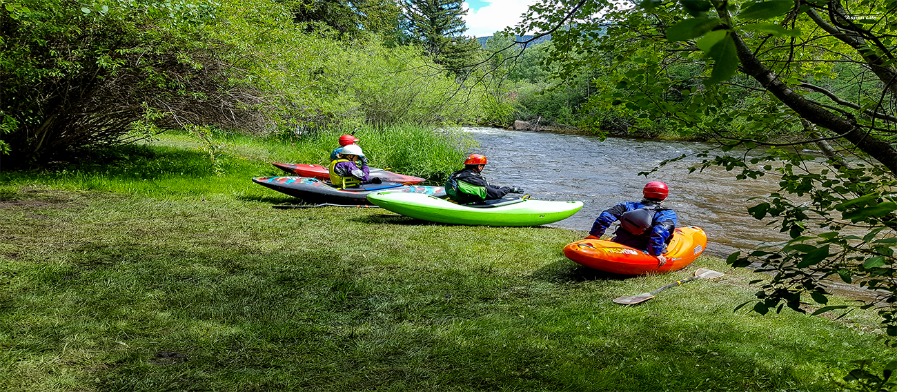 Group of Kayakers sitting on the bank of the Rio Grande River in Aspen, Colorado in July 2024